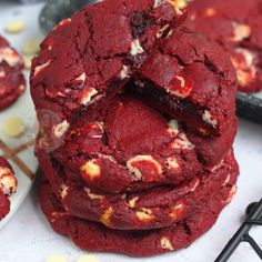 red velvet cookies stacked on top of each other with white and yellow dots around them