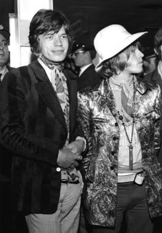 black and white photograph of two men in suits and hats standing next to each other