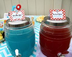 there are two jars with drinks in them on top of a blue and white table cloth