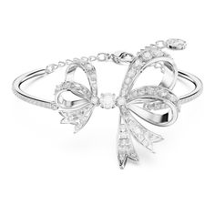 The most beautiful way to wrap your wrist, this bow-inspired bangle is one of the shining highlights of the Hyperbola family. The bangle itself features a pavé of clear crystals, while the central ribbon design is elegantly adorned with more clear stones using the chattonage technique. Wear this rhodium plated piece of jewelry to create a look of modern elegance, or present it to someone as a gift on a special occasion. Diamond Ribbon, Bow Bracelet, Swarovski Bracelet, Ribbon Design, Jewelry Lookbook, Large Bow, Gold Ribbons, White Bow, Clear Crystals