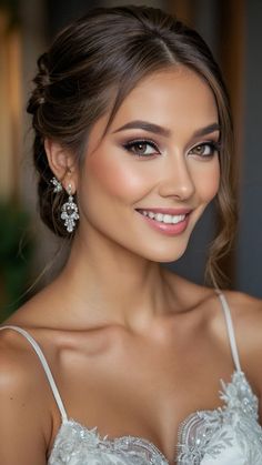 a beautiful woman in a white dress smiling at the camera