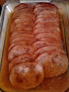 there is a large sausage in the pan on the stove top, ready to be cooked