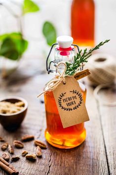 a jar filled with honey sitting on top of a wooden table next to some nuts