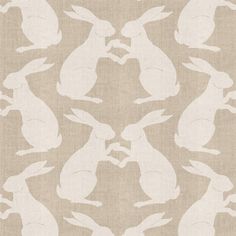 the silhouettes of rabbits are shown in white on beige linen, as well as an image