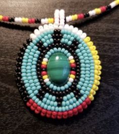 a beaded necklace is shown on a table