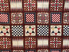 a quilt with many different designs and colors on it's sides, all in squares