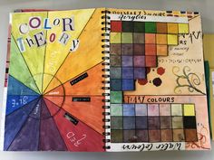 a spiral notebook with an open color theory book on it and the words'color theory'written in cursive writing