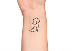 a hand with a small dog tattoo on it's left wrist and the outline of a poodle