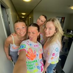 four girls with painted hands posing for the camera