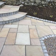 an outdoor patio with stone steps and landscaping