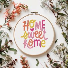 a cross - stitch pattern with the words home sweet home surrounded by flowers and leaves