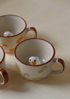 three coffee cups with ducks painted on them