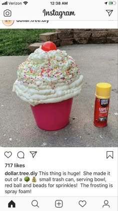 a cupcake with sprinkles on top is sitting next to a spray bottle