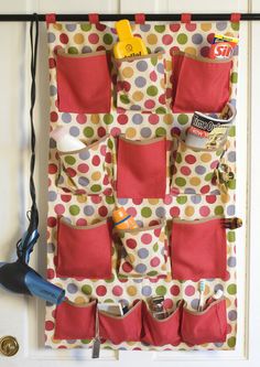 a wall hanging organizer with pockets and tools