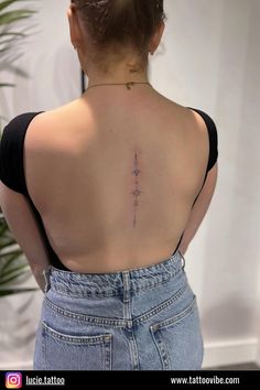 a woman with a cross tattoo on her back