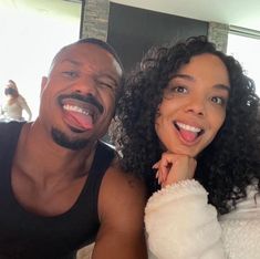 a man and woman are posing for a photo in front of a mirror with their tongue hanging out