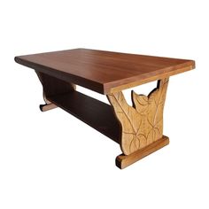 a wooden table with an animal motif on the top and shelf below it, against a white background