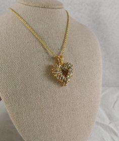 Sparkling CZ's adorn this beautiful openwork gold plate heart necklace made by Roman's. .  Pendant is 1 by 3/4 inches and the chain is 18. 43 cz's...none missing. Stamped "Roman" on the back of the bail of the pendant. It does not have the original chain on itvery slight difference in shades of gold. Beautiful pristine condition. Cubic Zirconia Heart Pendant Jewelry With Heart Beads, Gold Cubic Zirconia Heart Pendant Necklace, Heart Beads Cubic Zirconia Jewelry For Gifts, Cubic Zirconia Heart Beads Jewelry Gift, Cubic Zirconia Jewelry With Heart Beads For Gift, Gold Heart Pendant Necklace With Cubic Zirconia, Gold Heart Necklace For Anniversary, Elegant Open Heart Necklace For Jewelry Making, Wedding Heart Necklace With Birthstone Pendant