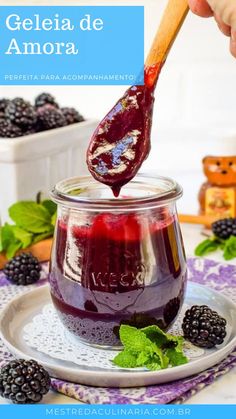 a spoon full of blueberry jam on top of a plate