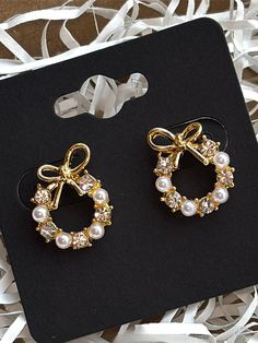 Get into the holiday spirit with these charming Bow Wreath Christmas Earrings! Featuring gold bows, sparkling rhinestones, and dainty pearls, these earrings bring a festive flair to any outfit. Perfect for holiday parties, cozy gatherings, or adding a little Christmas cheer to your day, they're lightweight and easy to wear all season long. Whether you're treating yourself or looking for a thoughtful gift, these gold stud earrings are a stylish way to celebrate the magic of Christmas. Christmas Jewellery, Bow Wreath, Stud Earrings Gold, Gold Jewelry Earrings, Earrings Christmas, Jewellery Gold, Wreath Bow, Gold Stud Earrings, Wreath Christmas