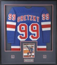 an autographed hockey jersey is displayed in a framed frame with the number 99 on it