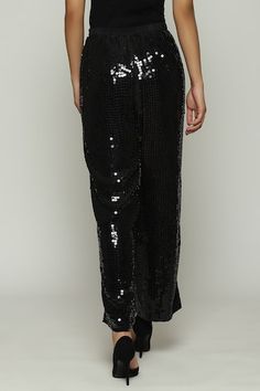 Black straight fit pant with tonal sequin embellishments. - Aza Fashions Festive Embellished Straight Pants, Chic Festive Embellished Bottoms, Embellished Trousers For Night Out, Chic Embellished Festive Pants, Embellished Evening Trousers, Sequin Straight Pants For Night Out, Embellished Straight Leg Party Bottoms, Embellished Straight Leg Bottoms For Party, Black Sequined Straight Leg Pants