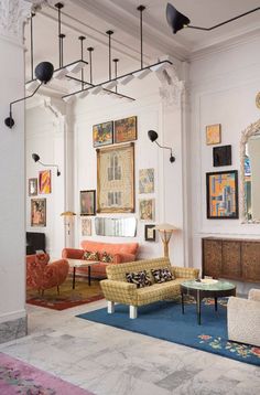 a living room filled with furniture and pictures on the wall