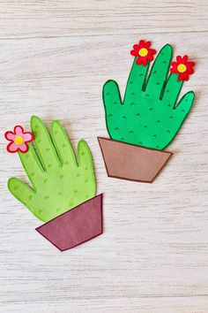 two paper cactus and flower pots on a table