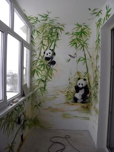 a panda bear mural in the corner of a room with bamboo trees on the wall