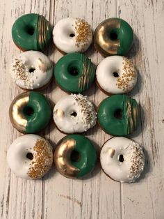 twelve green and white donuts with gold sprinkles