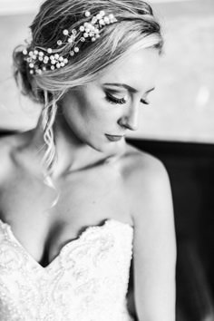 a woman in a wedding dress is wearing a bridal headpiece with pearls on it