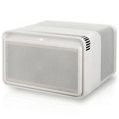 a white radio sitting on top of a white table next to a black and white clock