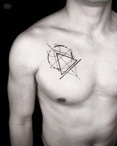 a black and white photo of a man's chest with a geometric tattoo on it