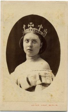 an old photo of a woman wearing a tiara