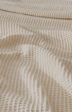 a white blanket with wavy lines on it