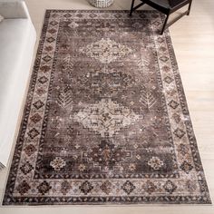 a large area rug with an ornate design on the top and bottom in brown tones