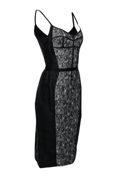 Look sultry and feel luxurious with this Dolce & Gabbana fitted dress. This dress flatters your shape with princess seam lines outlining a classic lace middle. Pair this with sky-high pumps and a mini bag for an elevated LBD look! Size 10 (IT 46) Shell: 50% Polyamide, 35% Cotton, 15% Silk Lining: 100% Silk Sleeveless Exposed back zipper Fully lined Soft sweetheart neckline Bust 36" Waist 30.5" Shoulder to hem 43" Formal Spaghetti Strap Dress With Contrast Lace, Elegant Fitted Lace Corset Dress, Formal Dresses With Spaghetti Straps And Lace Trim, Formal Spaghetti Strap Dress With Lace Trim, Black Sleeveless Dress With Boned Bodice, Sleeveless Lace Dress With Fitted Bodice For Cocktail, Black Lace Dress With Boned Bodice, Elegant Fitted Lace Dress With Lined Bodice, Elegant Lace Dress With Corset Back And Sweetheart Neckline