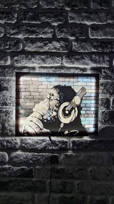 a brick wall with a painting of a man holding a guitar