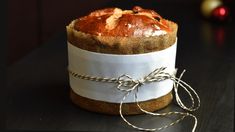 a loaf of bread wrapped in burlock and tied with twine on a table