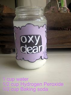 a close up of a jar on a table with the words oxy clean in it