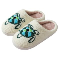 a pair of slippers with an image of a turtle on the front and bottom