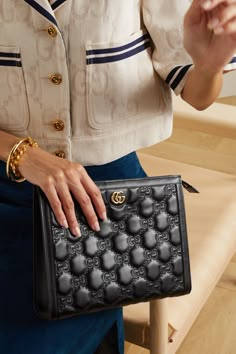 Gucci incorporates its signature 'GG' monogram into this pouch through meticulous embroidery for a matelassé effect. Made from supple black leather, it has a slim, structured shape and canvas-lined interior that'll fit your phone, cardholder and keys. The gold hardware adds a hint of polish. Gucci Bloom Clutch, Luxury Clutch Satchel For Shopping, Designer Pouch Clutch, Luxury Chic Canvas Satchel Bag, Gucci Pouch Outfit, Black Gucci Clutch, Luxury Formal Women's Phone Bag, Hand Bag Gucci, Luxury Clutch Purse