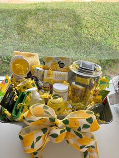 a basket filled with lemons and other items sitting on top of a window sill