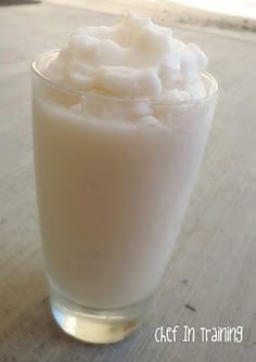 a glass filled with milk sitting on top of a table