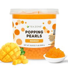 teazone popping pearls mango flavored gummy bears in a plastic container next to a white bowl