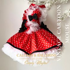 a red and white polka dot dress with black bow on the collar, matching headband