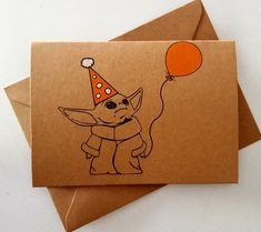 a card with an image of a baby yoda wearing a party hat and holding a balloon