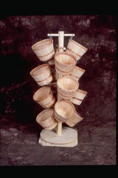 several wooden buckets stacked on top of each other in front of a black background