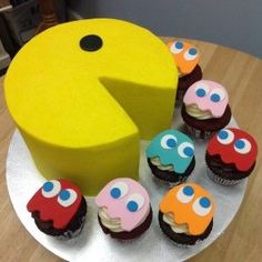 there are cupcakes on the plate with one piece cut out to look like a pacman