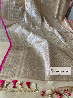 Elegant Champagne color ( off white ) Banarasi silk saree and muted gold zari silk saree with pink piping. Also comes with a running blouse piece.  Handloom Saree Dry wash only Off White Silk Saree For Wedding, Cream Tissue Silk Saree, Cream Raw Silk Saree, Wedding Tussar Silk Saree In Off White, Celebration White Tissue Silk Blouse Piece, Elegant White Tussar Silk Blouse Piece, White Art Silk Blouse Piece For Celebration, Off White Silk Saree For Festivals, Cream Self Design Saree